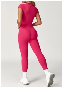 Macro shot of rose pink high-waisted gym leggings with V-shaped back seam and slim t-shirt