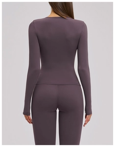 Back view of a purple long-sleeve yoga set showing high-elasticity fabric and body contour