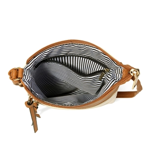 Detailed macro view of the interior compartment with striped lining and gold zippers