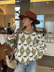 Green and white argyle knit sweater featuring vintage horse patterns and a crew neck