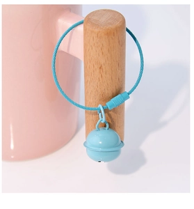 Detail of macaron blue bell keychain hanging on a wooden handle with a steel wire ring