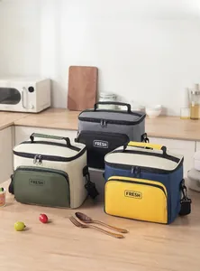 Three lunch bags in different colors with adjustable shoulder straps and top handles