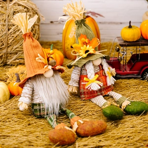 Detail of harvest gnomes with autumn decorations, maple leaves, and sunflowers