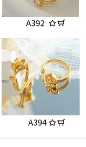 Detail of fox head shaped gold rings on a mirror surface with white lace decor