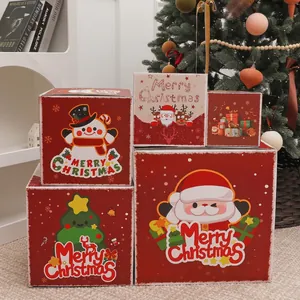 Set of four red and white Christmas gift boxes with festive Santa and reindeer patterns