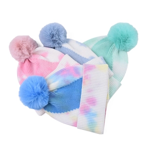 Tie-dye ribbed knit beanie for women with large faux fur pompom in multiple colors
