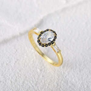 Detailed macro of vintage silver ring with oval clear stone and black diamond halo