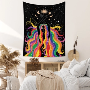 Detail of bohemian tapestry featuring a colorful long-haired woman with moon and sun icons