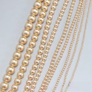 Macro shot of champagne pearls in various sizes with high-gloss finish for DIY jewelry
