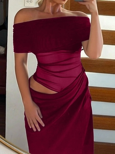 Detail of wine red one-shoulder top and side slit maxi skirt set for women in indoor setting