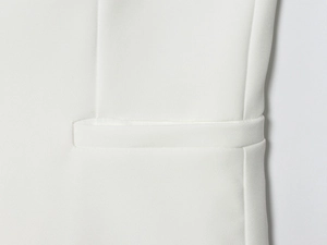 Détail de la couture sur une poche blanche d'un pantalon décontracté ajusté élégant