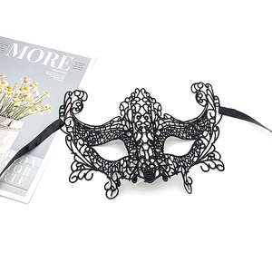 Detailed view of an intricate black lace masquerade mask with elegant silk ribbons