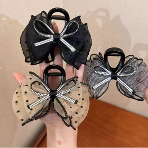 Elegant mesh bow hair claw clip with sparkling rhinestones, perfect for styling thick hair.