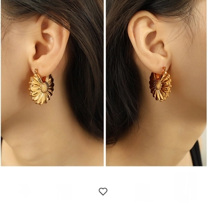 Detailed view of large hollow sunflower earrings in 18K gold plated titanium steel
