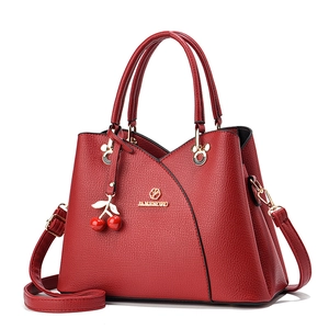 Elegant red leather handbag with lychee texture and cherry charm for women