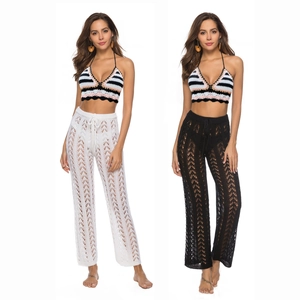 Detail of crochet halter top with striped pattern and hollow out wide leg beach pants