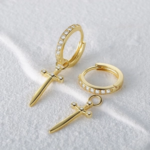 Elegant gold dagger hoop earrings with sparkling white zircons for a luxury retro style