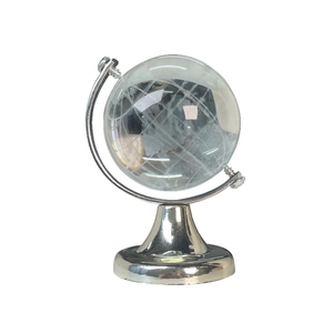 Minimalist crystal globe desktop ornament with polished silver metal stand on white background