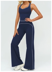 Close-up of white contrast stitching on high-waist flared navy blue yoga pants