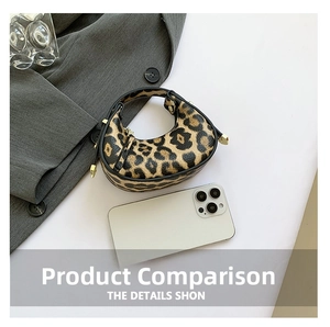 Mini leopard print crescent bag with golden zipper next to a smartphone for size reference
