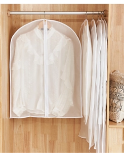 Close-up of translucent PEVA garment cover with zipper in a wooden closet setting