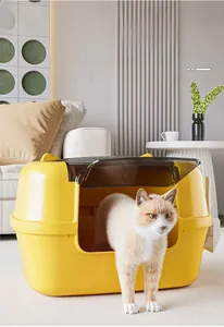 Detail of yellow enclosed cat litter box with translucent brown swinging entry door