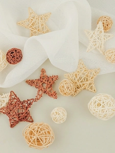 Close-up of star and ball shaped rattan ornaments in beige and reddish brown tones