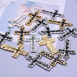 Dettaglio di ciondoli a croce in acciaio inossidabile 304 in finiture oro argento e nero