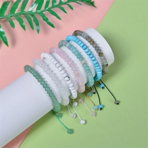 Set of seven adjustable natural stone abacus bead bracelets in pastel colors on display