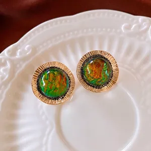 Vintage round gold earrings with textured edges and iridescent colorful inlay centers