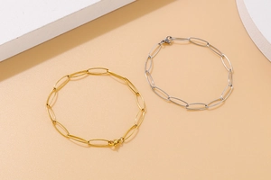Detailed close-up of oval link chain bracelets in gold and silver stainless steel