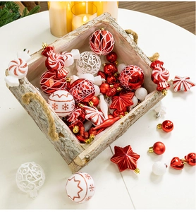 Red and white Christmas ornaments set in a rustic wooden basket with holiday decor