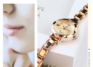 Detail of rose gold quartz watch with metal mesh strap and elegant round dial