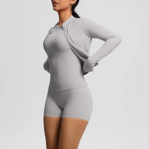 Three-piece light gray yoga set featuring zip-up jacket, vest, and high-waist sports shorts