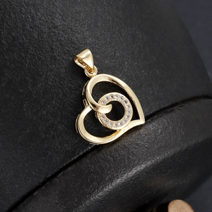 Macro shot of gold-plated 18K double heart pendant with micro-inset sparkling zircon