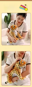 Close-up of soft leopard plush toy held by a person showing high-quality fabric texture