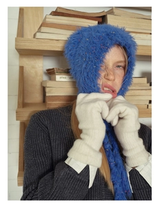 Detail of soft blue wool blend knit gloves with colorful flecks and warm touch screen tips