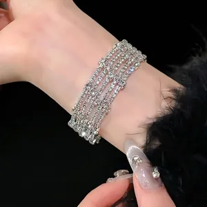 Elegante meerlaagse gekruiste zilveren armband met sprankelende strass-steentjes en zirkoon