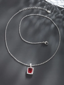 Elegant silver necklace with rectangular red gemstone pendant and diamond halo detail
