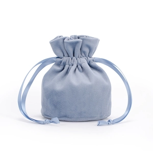 Detail of light blue velvet drawstring bag with soft texture and matching satin ribbons