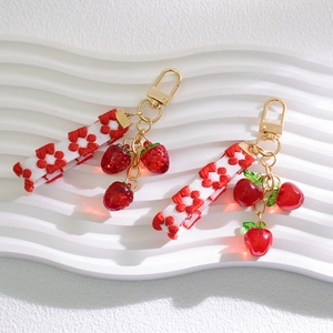 Creative fruit keychain with red strawberry charms and floral embroidered ribbon for bags