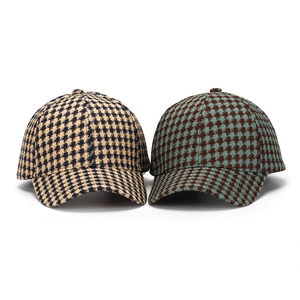 Close-up of houndstooth wool baseball caps in yellow-black and blue-brown patterns