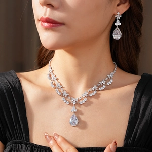 Close-up of double-layer flower necklace and water drop zircon earrings on a model