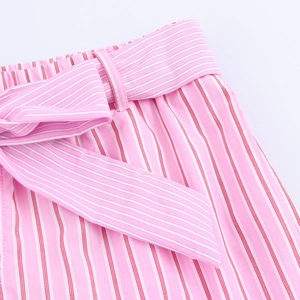 Detail of pink and white striped trousers featuring elastic waist and matching tie belt
