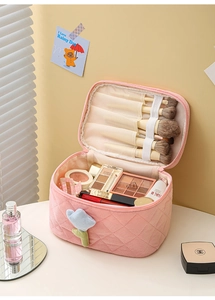 Detail view of pink corduroy makeup bag with tulip decor and dedicated brush slots