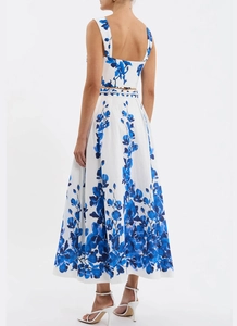 Detail of floral backless crop top and high-waist A-line skirt with blue patterns