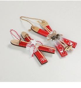 Detail of red and natural wooden sled ornaments with bells and faux fur for Christmas