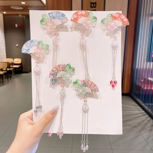 Detail of five floral hanfu hair clips with elegant tassels and cherry blossom charms