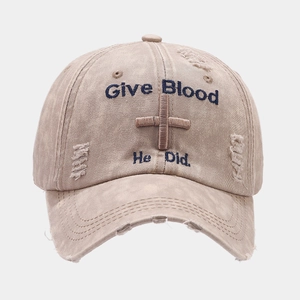 Detailed embroidery of Give Blood text and cross on vintage washed khaki baseball cap