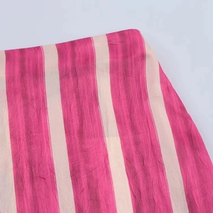 Detail view of lightweight pink and beige vertical striped fabric with fine texture